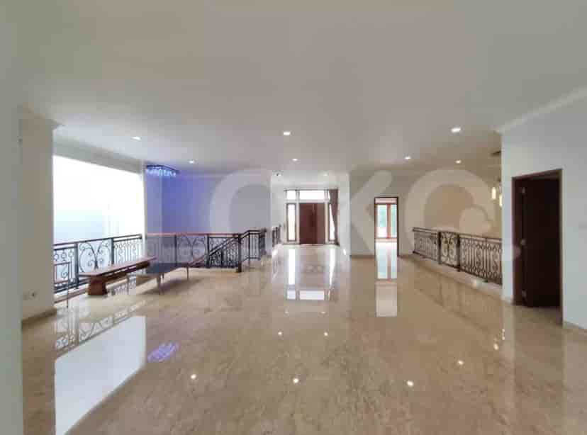 An open-plan second-floor area with marble flooring, a balcony, and a wrought-iron railing.