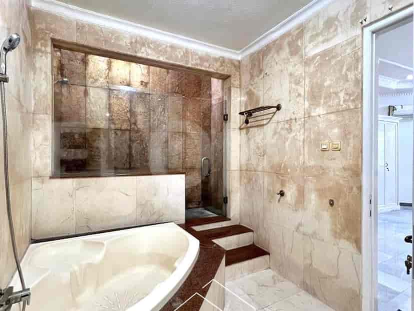 A bathroom featuring a bathtub, shower, and a vanity area.