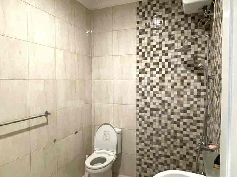 Bathroom with a shower, toilet, and sink.