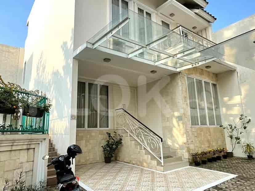 A modern two-story house with a stone facade, glass canopy, and a motorcycle parked in the driveway.