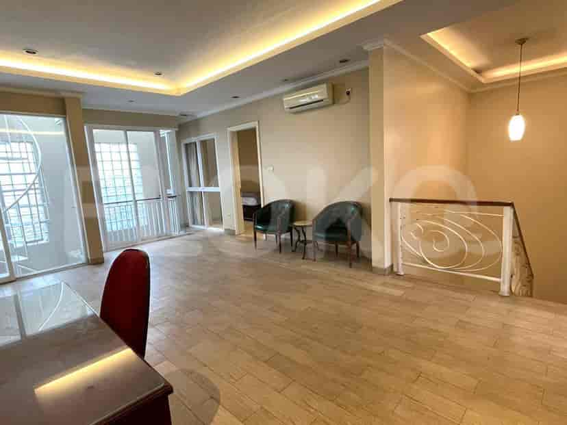 Upstairs living area with seating, overlooking a balcony, and a spiral staircase.