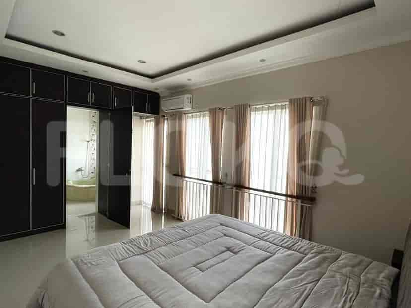 A master bedroom with a large bed, wardrobe, and ensuite bathroom.