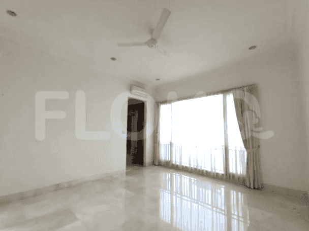 A spacious living room with marble flooring, air conditioning, and large windows.
