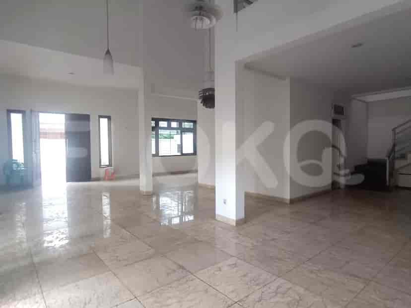An expansive living room with marble flooring, high ceilings, and large windows that provide ample natural light.