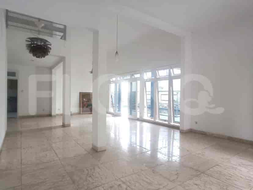 Another view of the living room with glass doors and large windows.