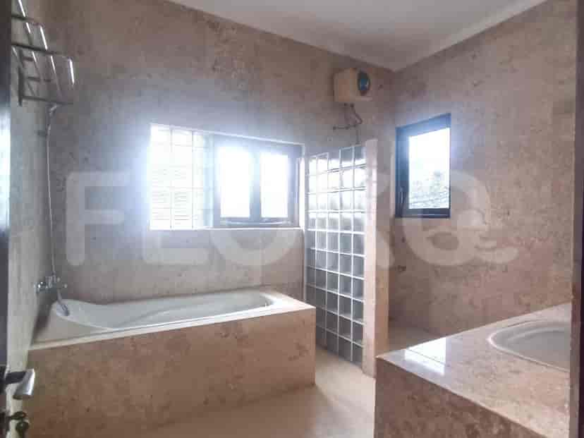 A spacious bathroom with a bathtub and shower area.