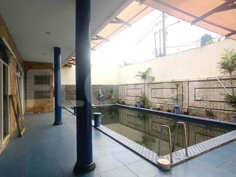 The outdoor pool area with a swimming pool and plants.