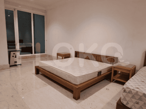 Bedroom with wooden bed, nightstands, and large windows.