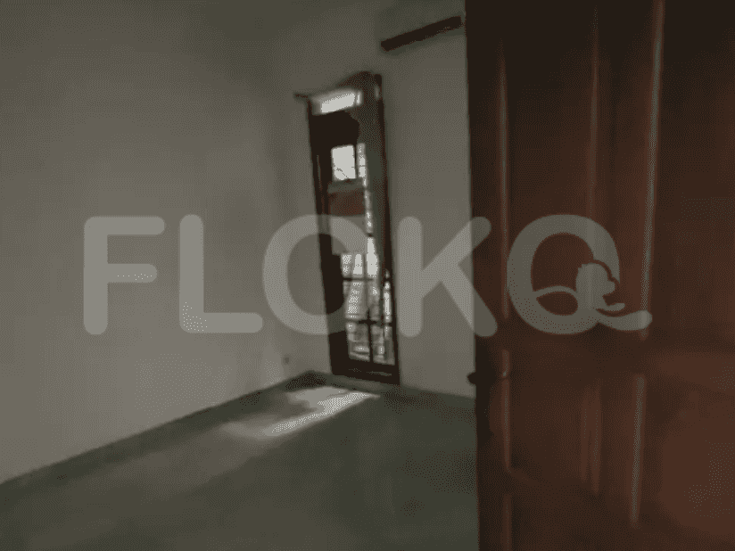 A room with a door to the right, showing an air conditioning unit.