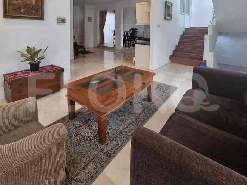 A living room with a wooden coffee table, marble flooring, and traditional furnishings.