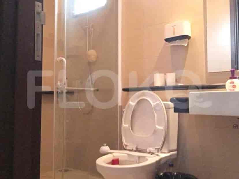 A modern bathroom with a glass shower enclosure and a white toilet.