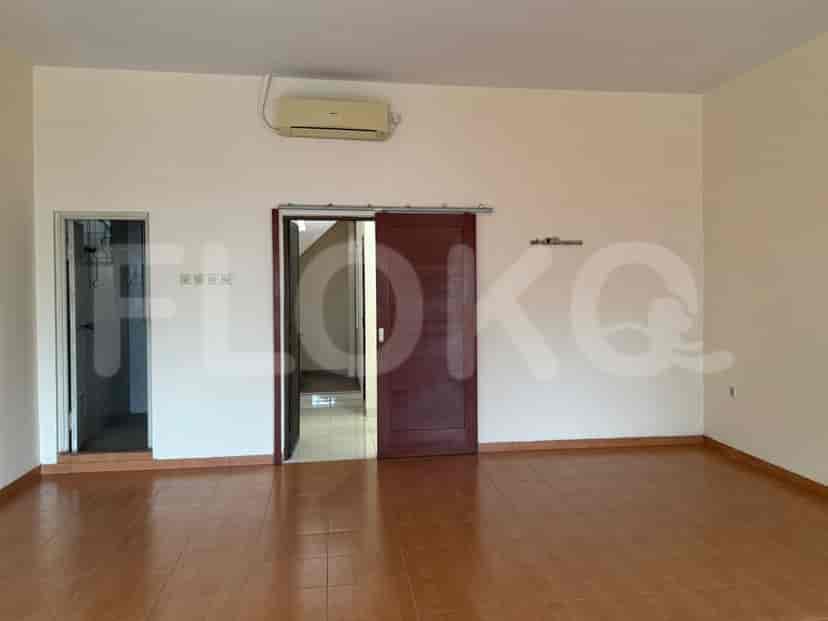 Living room with brown tiled floors, a sliding door, and an air conditioning unit.