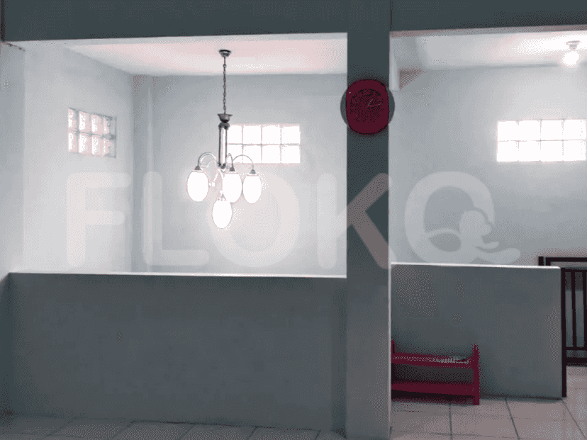 A chandelier illuminates the living area.