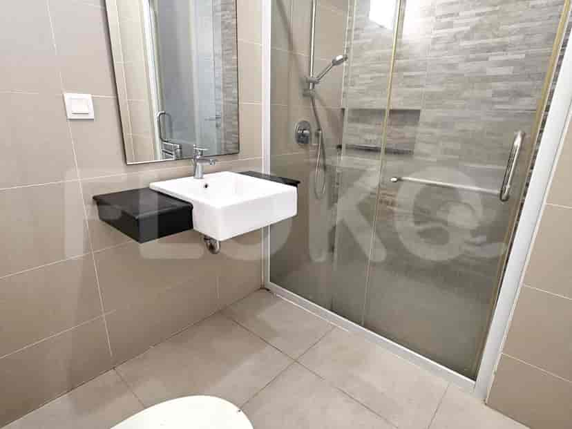 A modern bathroom with a glass-enclosed shower, a floating vanity, and a large mirror.
