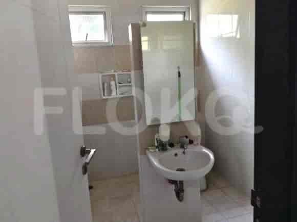 A bathroom with a sink, mirror, and partially visible shower area.