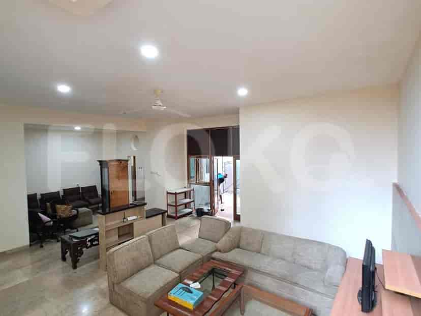 A lounge area with multiple sofas, a coffee table, and access to the outdoors.