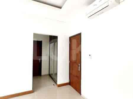 A bedroom with an air conditioning system, wooden door, and wardrobe access.