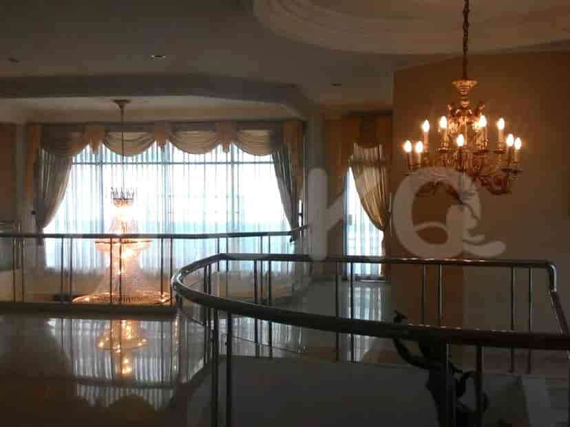 A staircase leading to a second floor, with a chandelier.