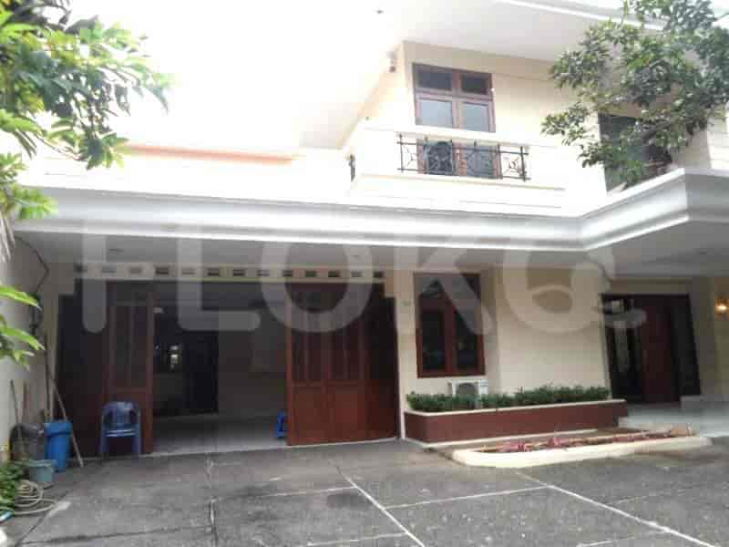 An overview of the property's exterior showcasing the house facade, garage, and driveway.