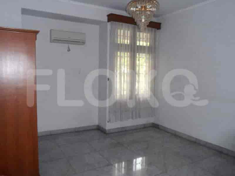 A bedroom with tiled flooring, white walls, and a chandelier, including a wardrobe and an AC unit.