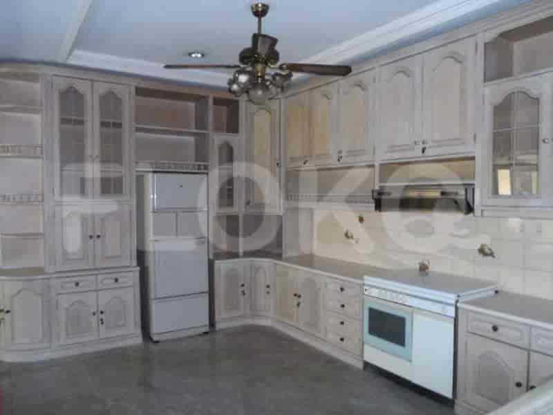 A well-lit kitchen with a combination of cabinets, appliances, and functional space.