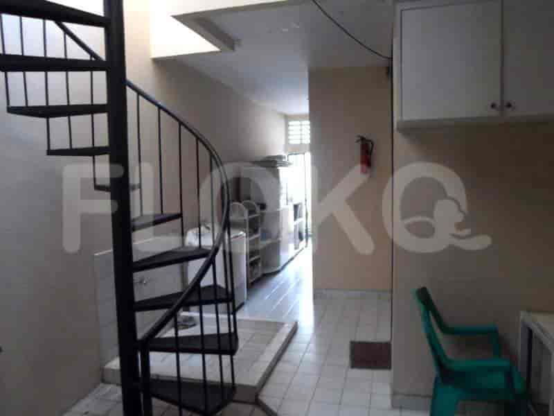 An open, spiral staircase leading up to another floor of the house.