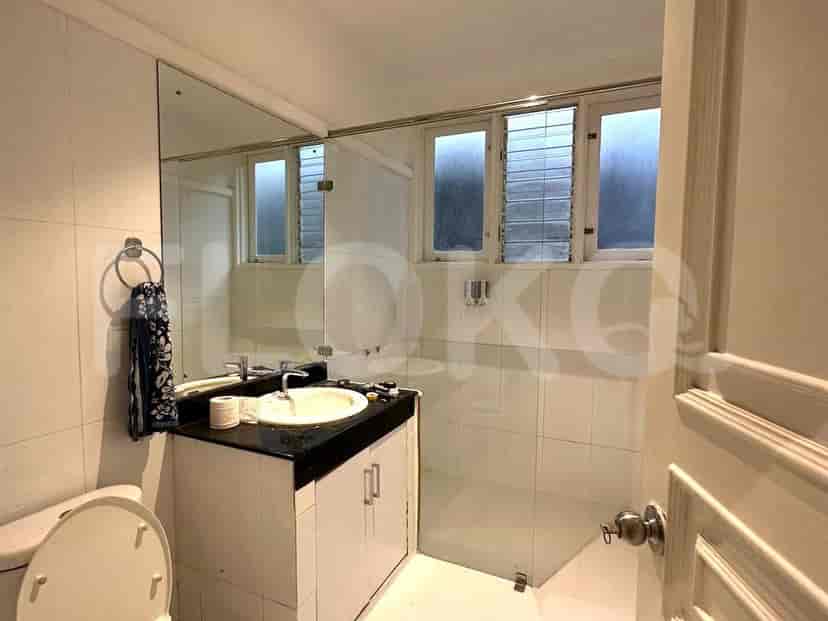 A bathroom with a vanity, mirror, and a glass shower enclosure.