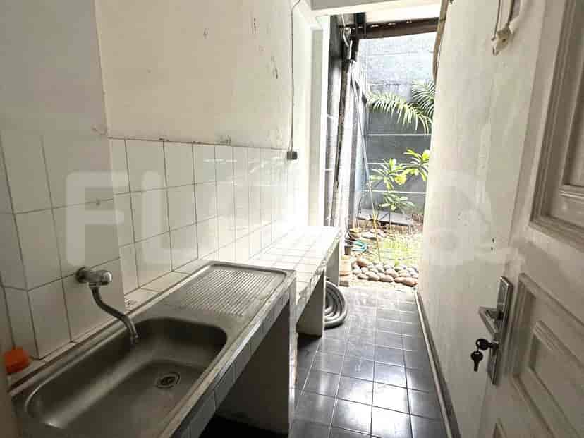Laundry area with a sink and a small outside access.