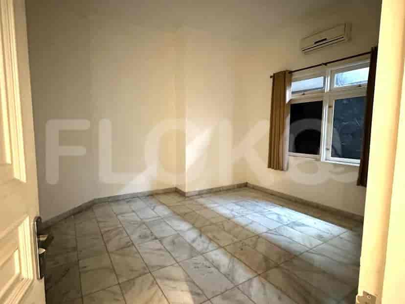 Bedroom with marble flooring, air conditioning and window with curtains.