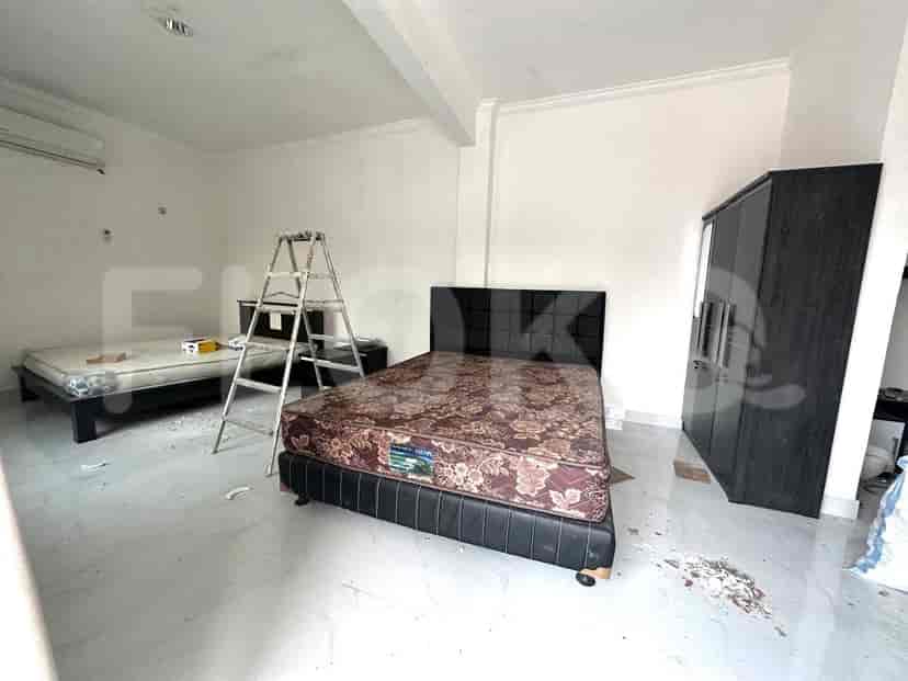 A bedroom with two beds and a wardrobe.