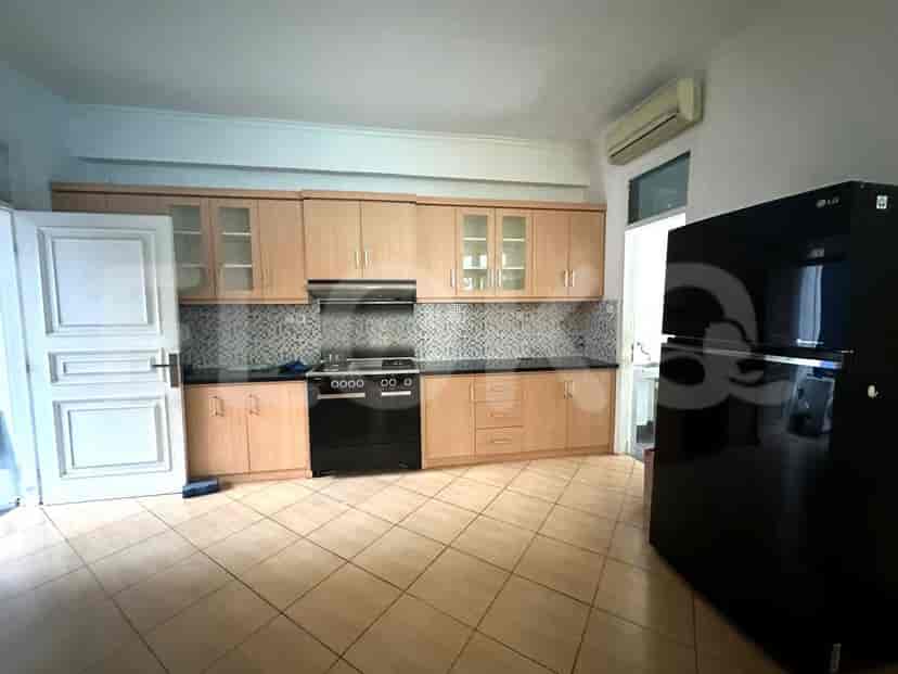 The kitchen features wooden cabinets, granite countertops, and a black refrigerator.