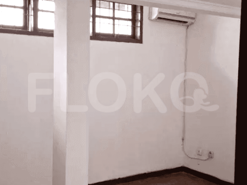 A room with white walls, a window, and an air conditioning unit.