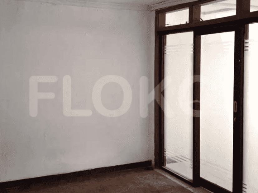 A room with sliding doors, a wooden frame, and a tiled floor.