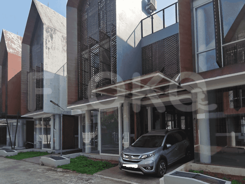 Modern townhouses with a contemporary design, featuring large windows, wooden accents, and a covered entrance.