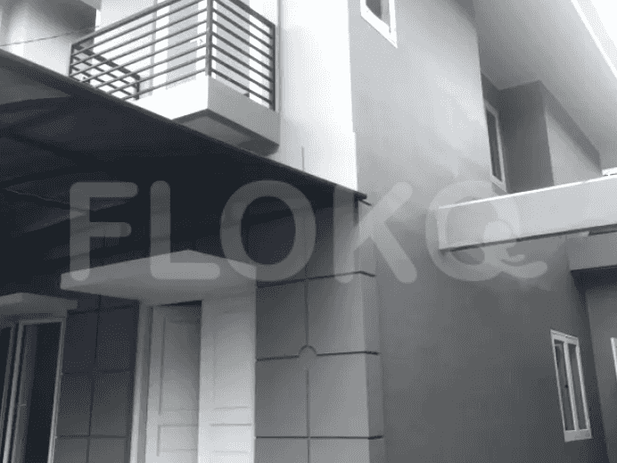 Modern two-story house with grey walls, a balcony, and a carport.