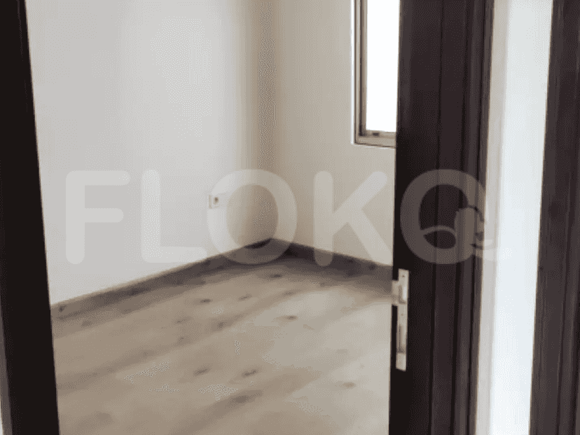 Bedroom interior with wooden flooring and white walls.