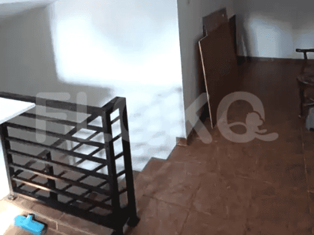 A staircase with iron railings leading to the upper floor.