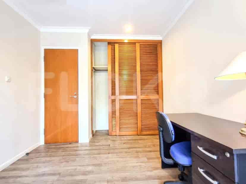 A bedroom and study area with a wardrobe and desk.