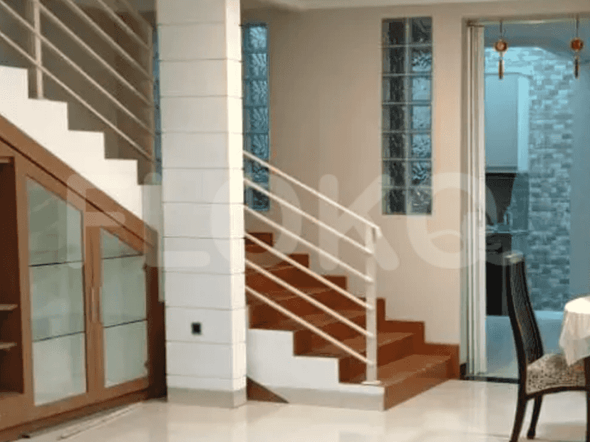 A staircase with wooden steps, white walls, and glass block windows.