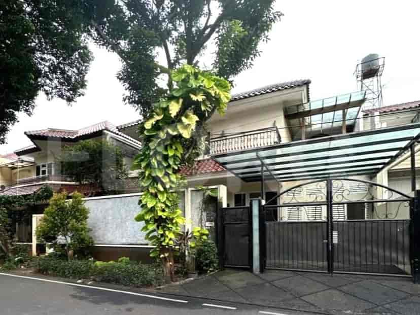A two-story detached house with a gated entrance, carport, and mature tree.