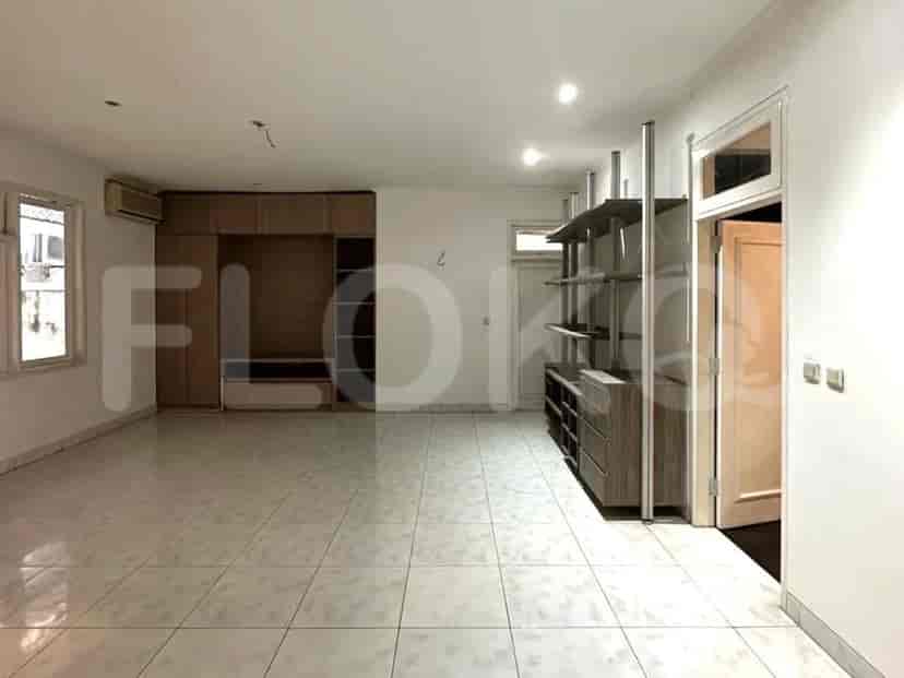 A living room with a storage unit, air conditioning, and tiled floors.