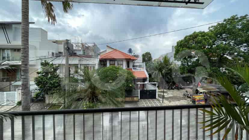 A view of surrounding houses from a balcony, showing the neighborhood and streetscape.