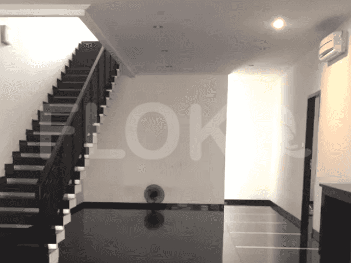 Interior view of a staircase with black risers and dark wooden handrail, leading to the upper floor.