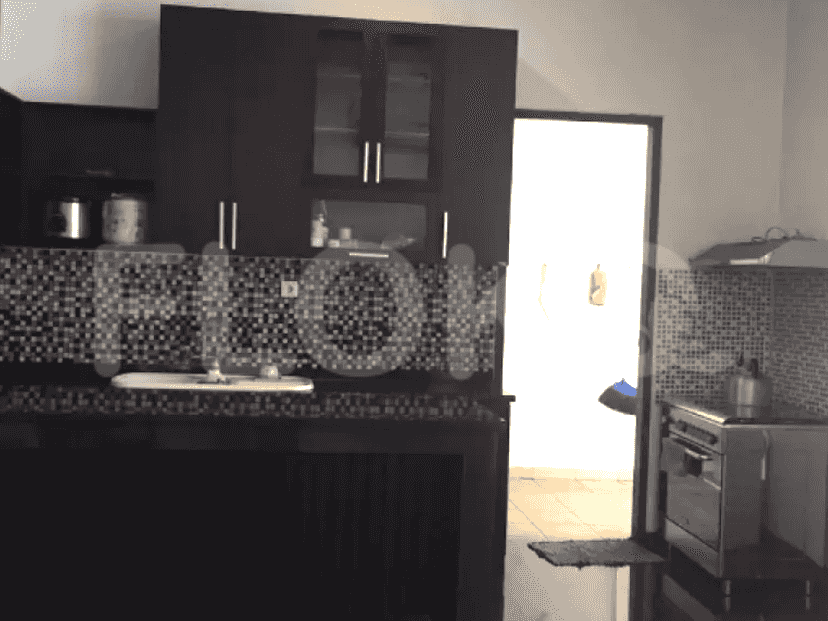 The kitchen features dark cabinetry, built-in appliances, and a tiled backsplash.