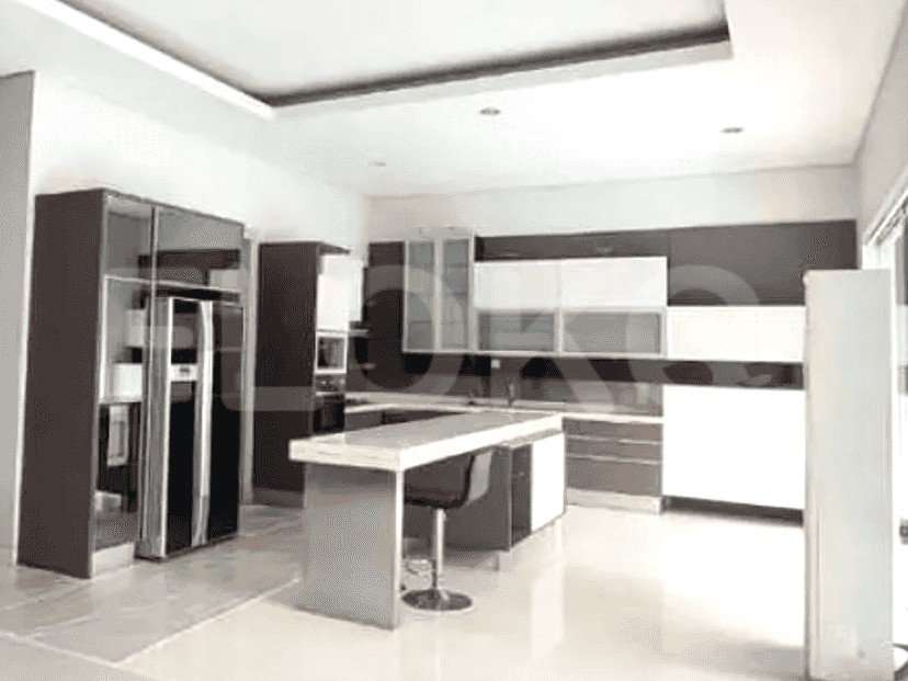 A modern kitchen with dark cabinetry, a central island, and stainless steel appliances.