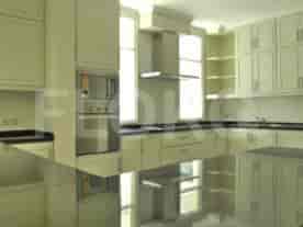 A modern kitchen with white cabinets, black countertops, and stainless steel appliances.