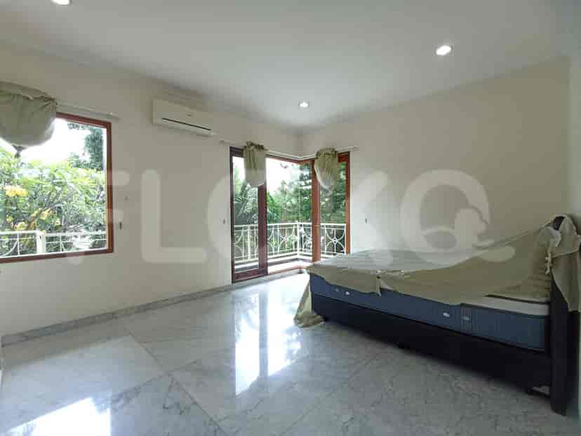 A bedroom with a balcony, a double bed, and marble flooring.