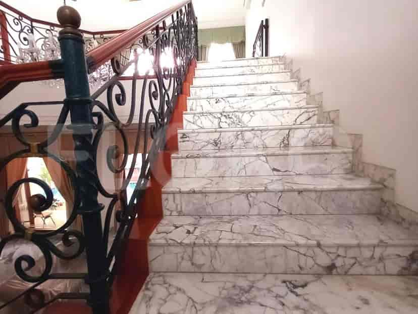 A grand staircase with marble steps and a decorative wrought-iron railing.