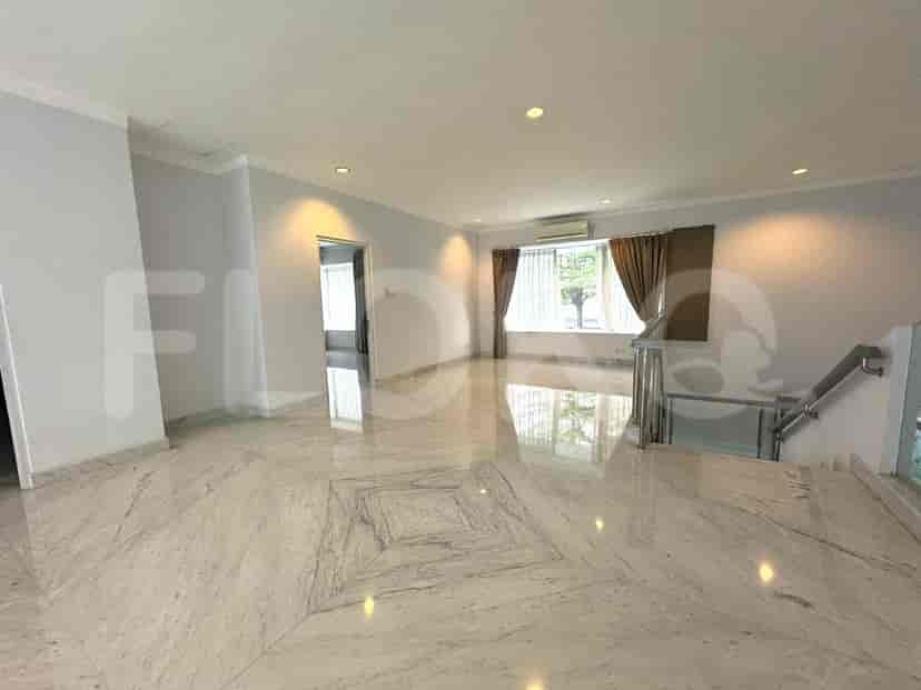 An upper-level living area with marble flooring, white walls, and a balcony with a glass railing.