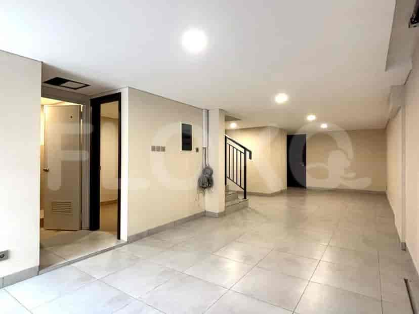 An open space on the ground floor with tiled flooring.